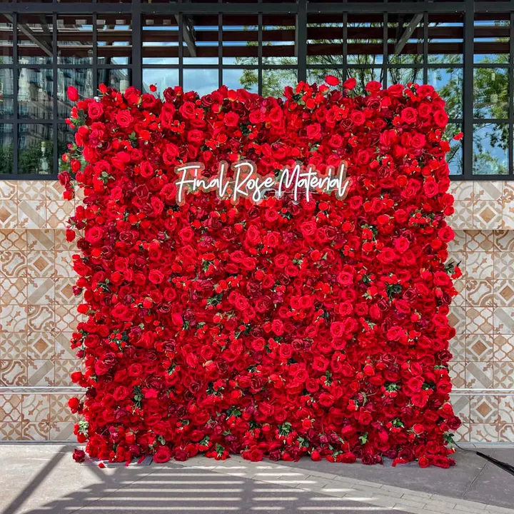 A large, vibrant red floral wall with the text "From Rose Matter" prominently displayed, set against a backdrop of glass and steel structures.