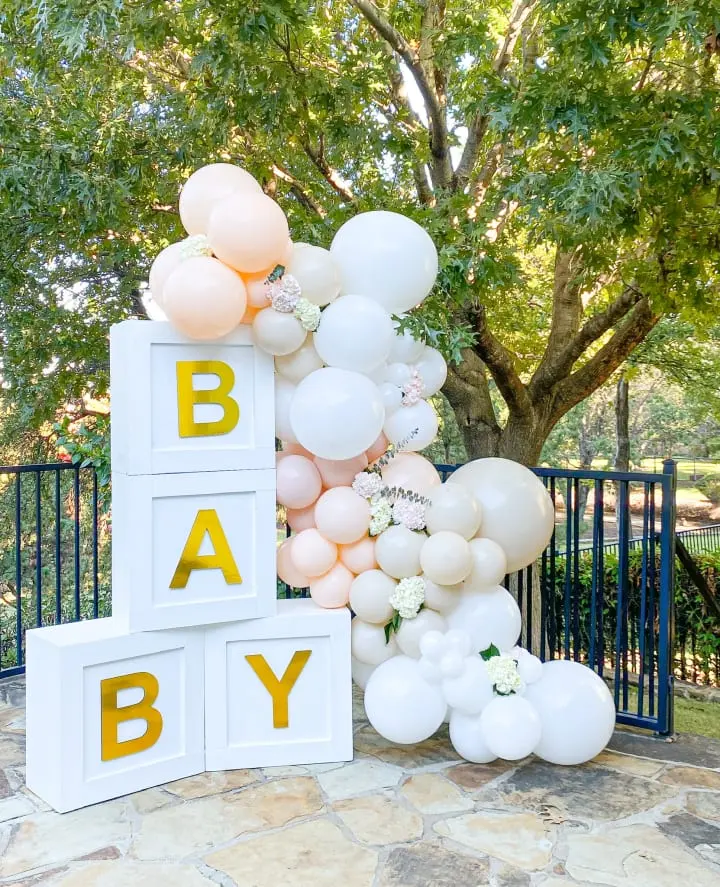 a bunch of balloons that are in front of a sign that says baby on it and a bunch of balloons that are in front of a sign that says baby on it