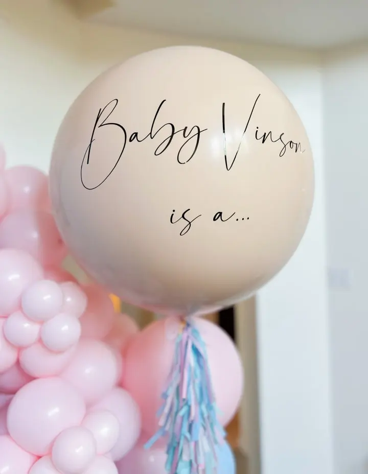 a bunch of balloons with writing on them that say, baby venus is a balloon with a tassel on it