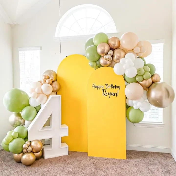 a balloon arch with a number four and balloons in the shape of numbers and balloons in the shape of numbers
