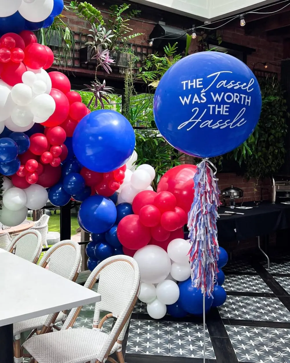 a bunch of balloons that are on a table in a room with a table and chairs and a sign that says, the toast was worth the mess