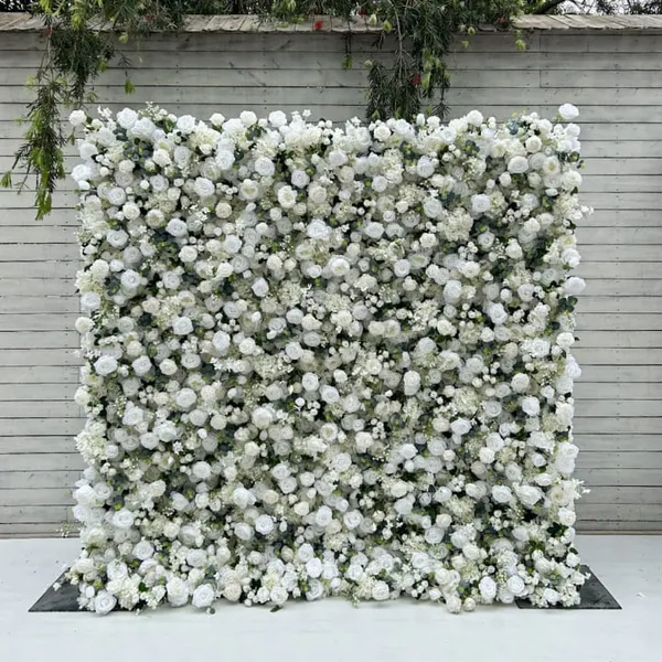 A large white flower wall is covered in white flowers, creating a visually striking and colorful display.