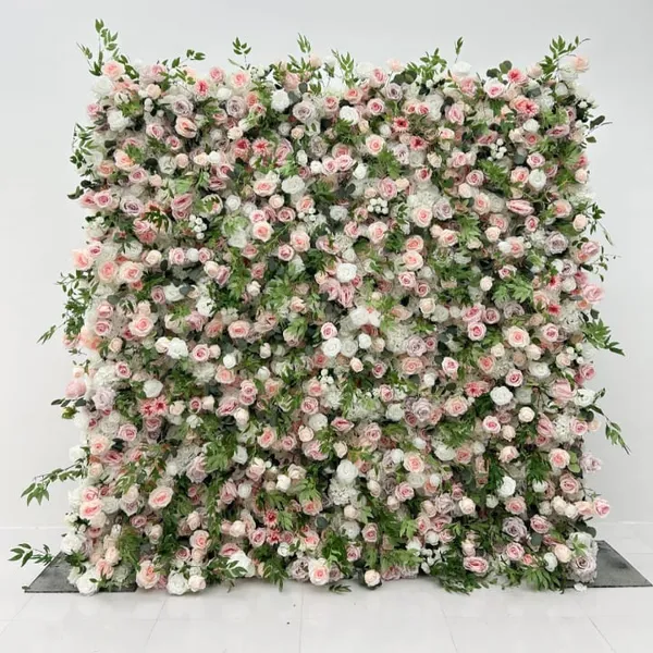 A large, beautifully decorated wall is covered in a vibrant, pink and white flower arrangement, creating a visually striking and colorful scene.
