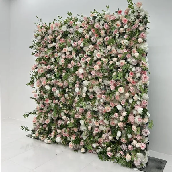 A large, colorful, and lushly planted wall is covered in pink flowers, creating a visually appealing and vibrant scene.
