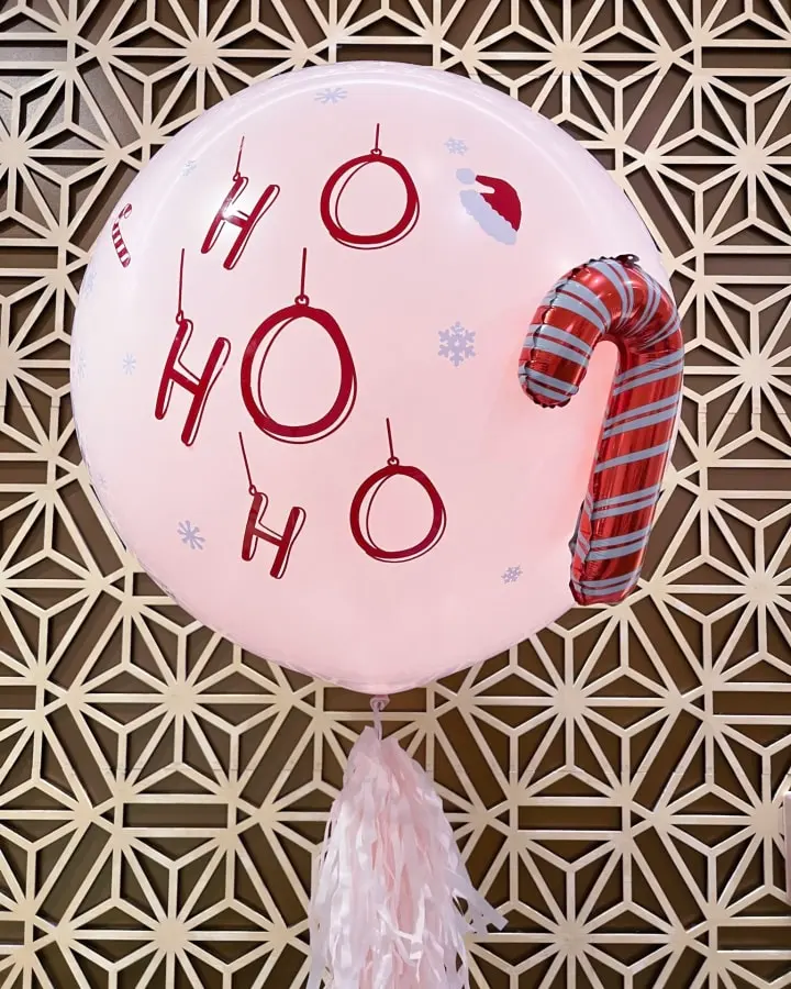 a balloon with the word oh oh on it hanging from a wall with a tasseled decoration on it