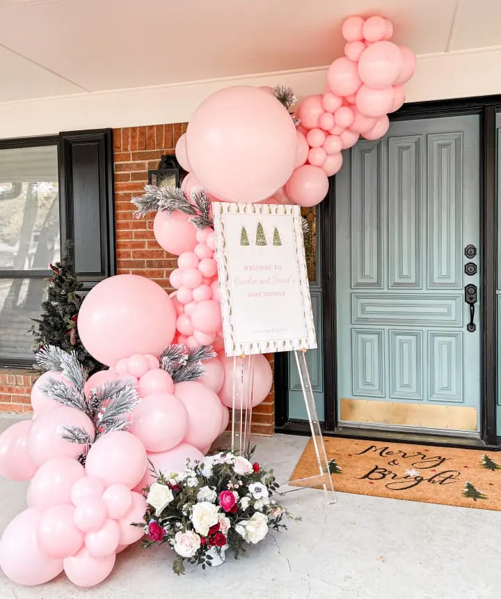 a bunch of balloons and a sign in front of a door with a welcome sign in front of it