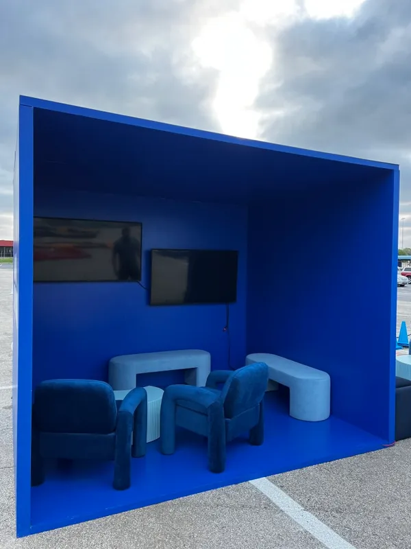 The image features a blue room with a blue wall, a blue couch, and a blue chair.