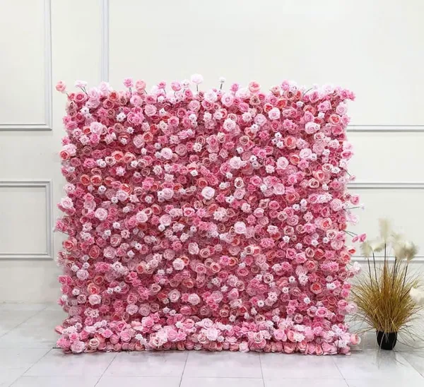 a pink flowered wall with a potted plant in the corner of the room and a white wall behind it