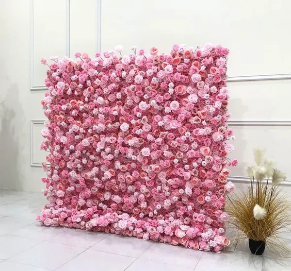 a large pink flowered wall next to a potted plant on a white tiled floor in a room
