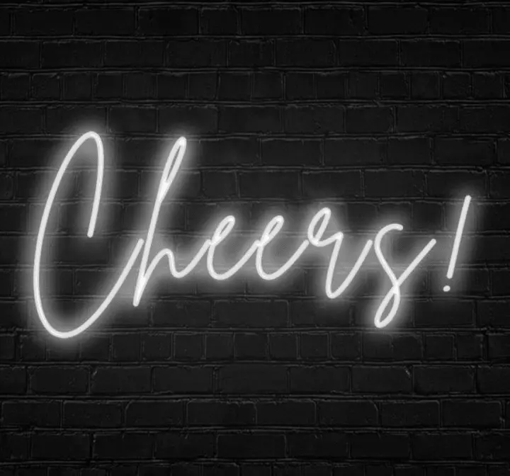 a neon sign that says cheers on a brick wall with the word cheers lit up in the middle of it