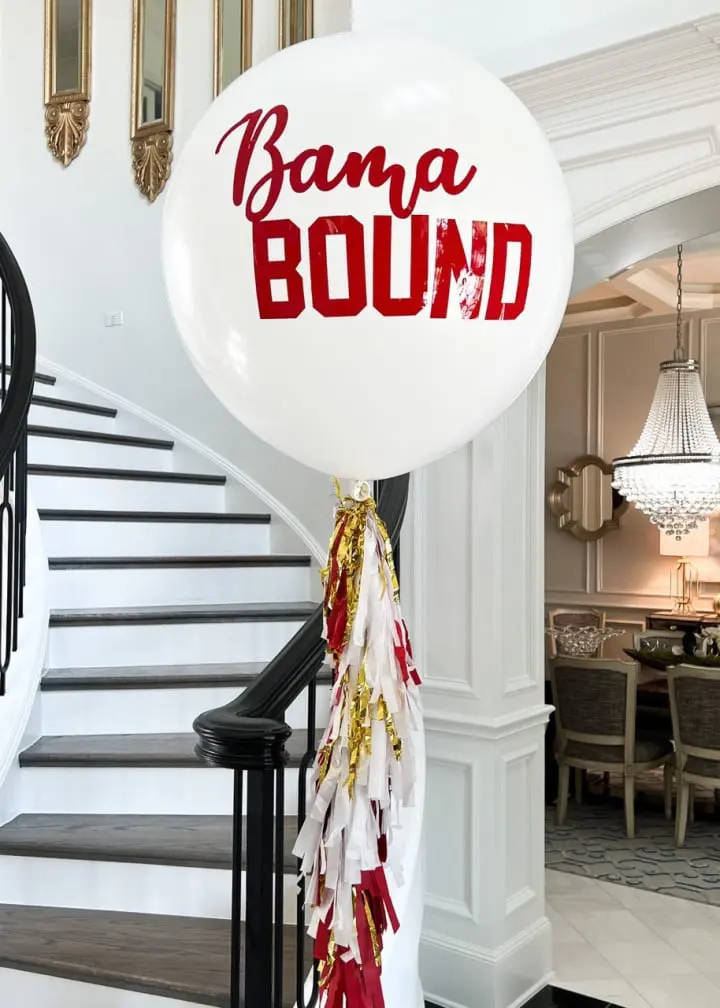 a white balloon with the words obama bound on it in front of a staircase with a red and white ribbon tied to it