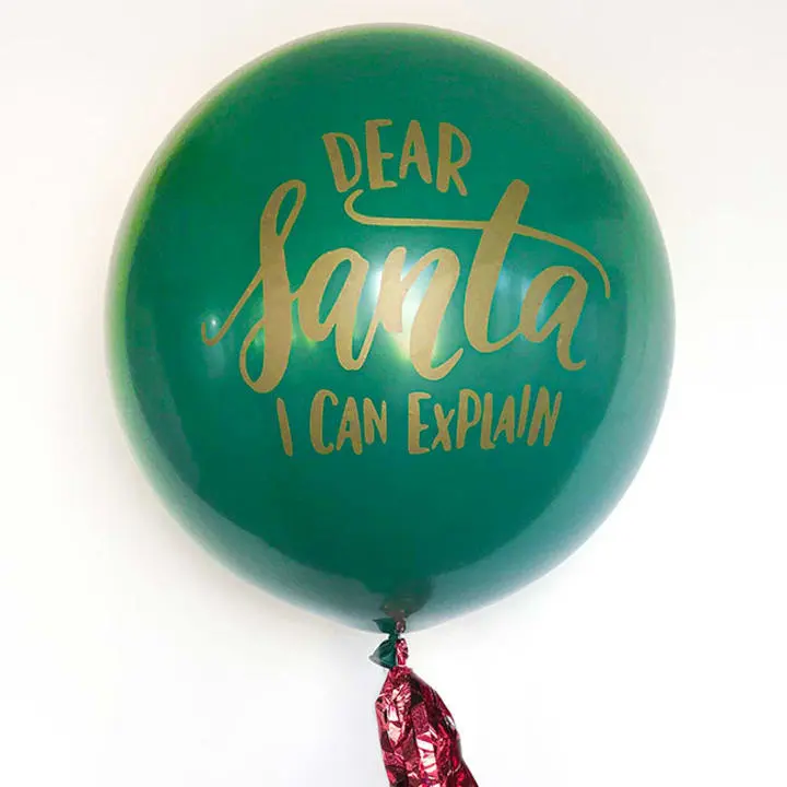 a balloon that says dear santa i can explain on the side of the balloon with a tassel on the end of the balloon