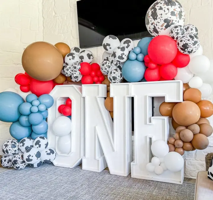 a large balloon display in the shape of the letter'n'in front of a wall of balloons