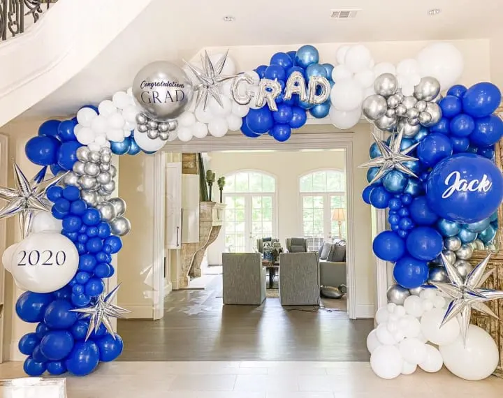 a blue and white balloon arch decorated with stars and snowflakes for a new year's eve party