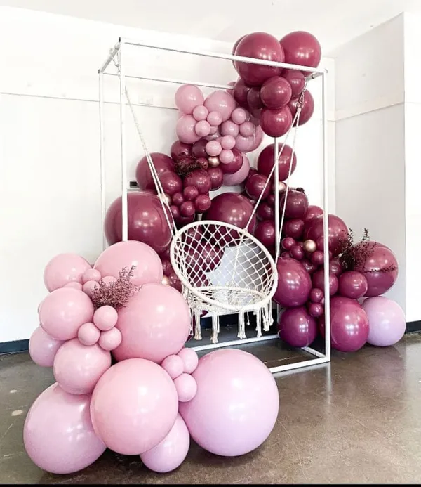 swing set with magenta balloons