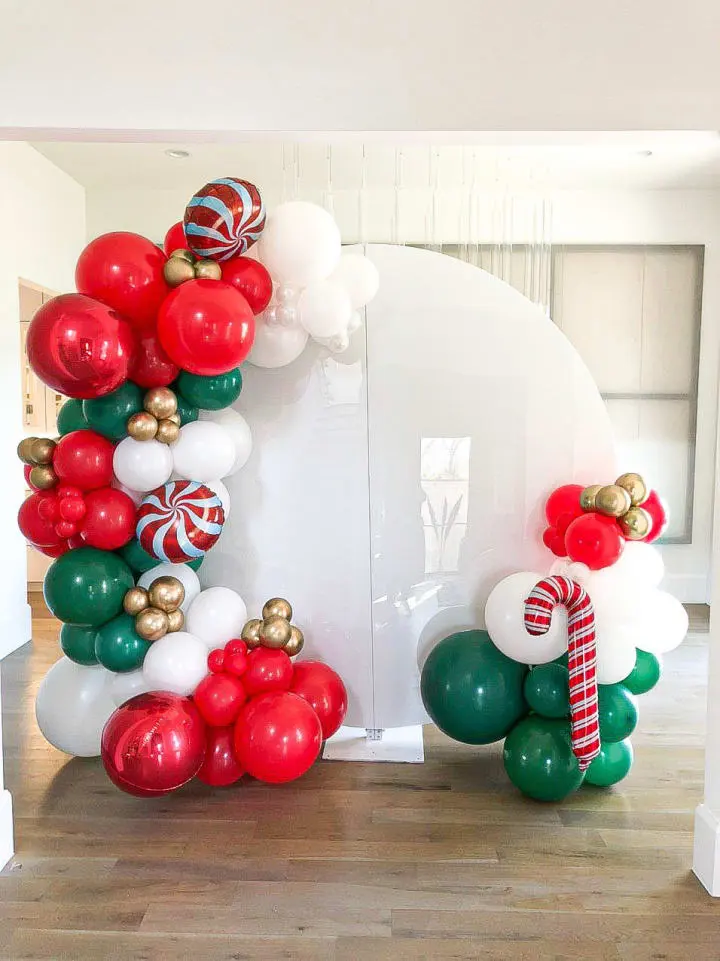 a bunch of balloons that are in the shape of a christmas tree and candy canes on a table