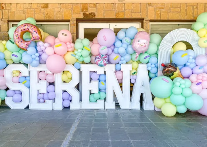 a large balloon sign with the word serena spelled out of balloons and a doughnut on top of it